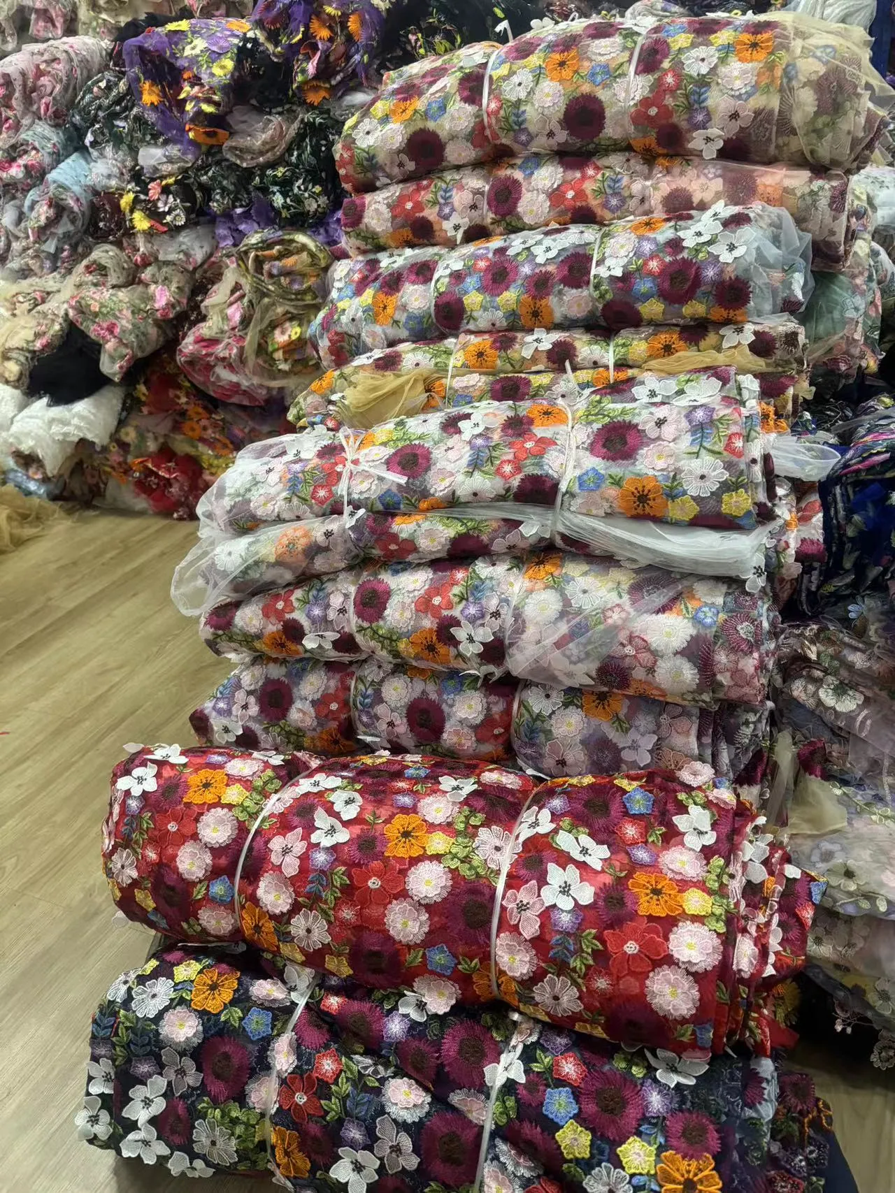 Rolos de tecidos bordados no armazém